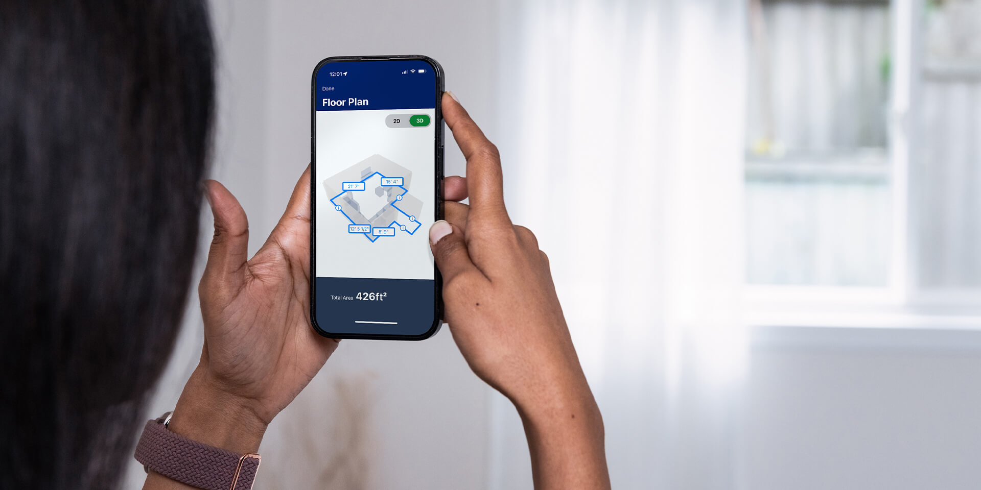 Woman using mobile phone and Lowe's App to measure room