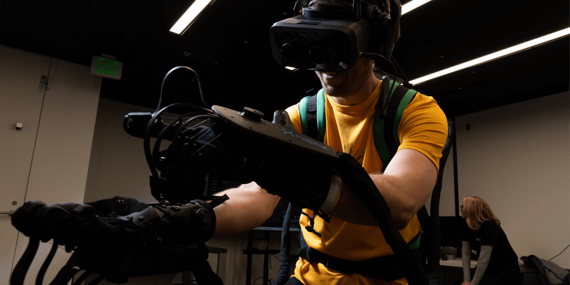 Lowes Innovation Labs team member wearing haptics enabled gloves with tactile feedback for virtual reality experience. 