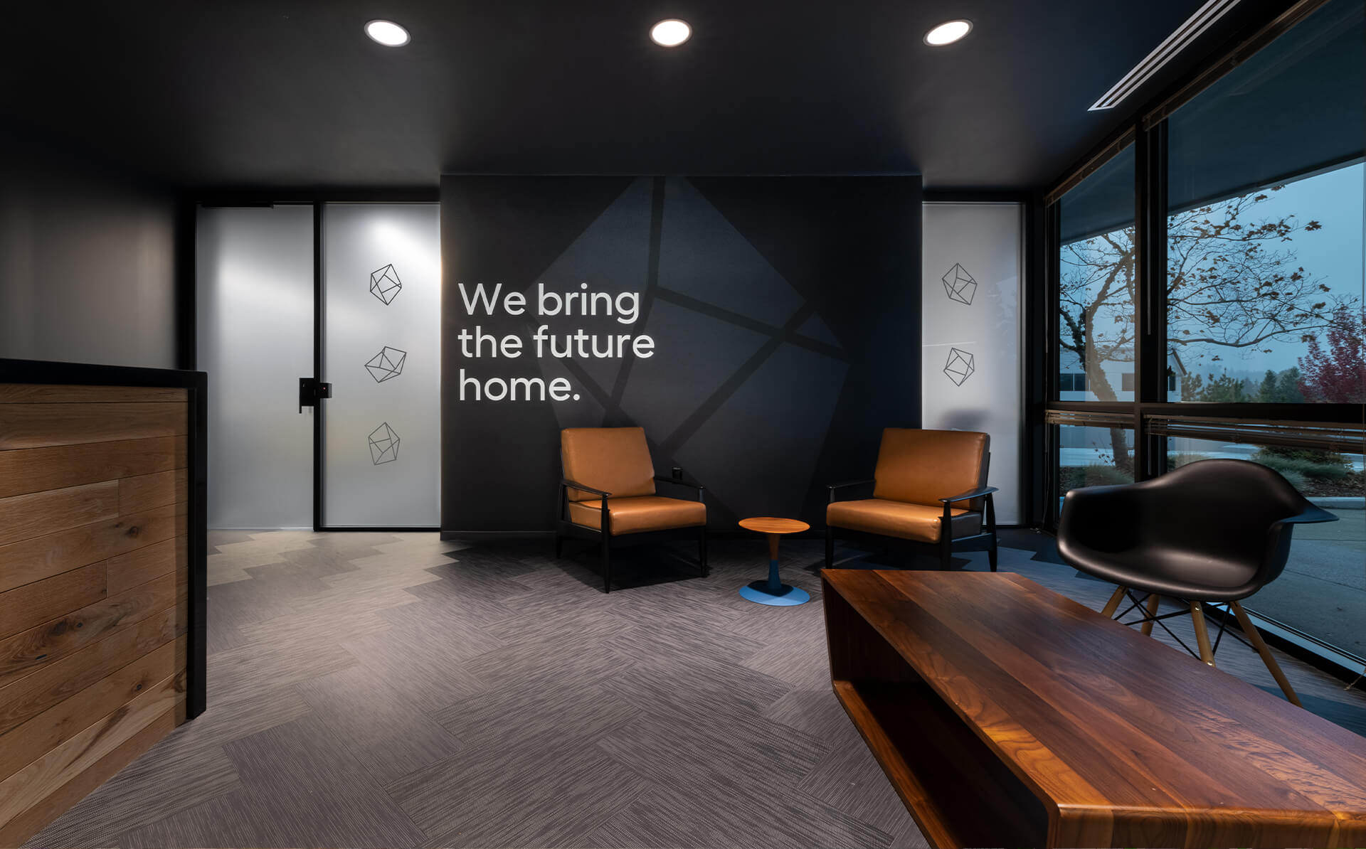 Image of Lowes Innovation Labs office lobby in Kirkland, Washington, with our tagline on the wall that reads 'we brings the future home'