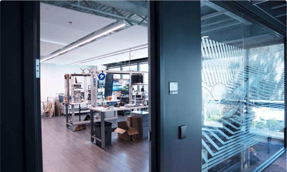 Doorway view of Lowe's Innovation Labs Maker Space - a room of assorted machines, circuits, and research equipment.