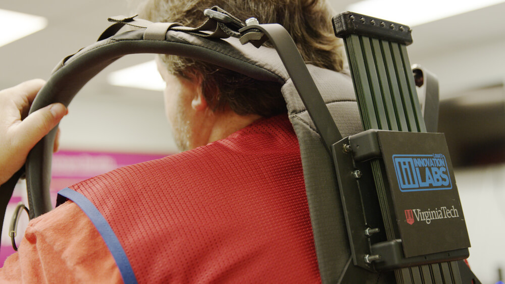 Lowes Home Improvement associate putting on soft robotic exoskeleton.