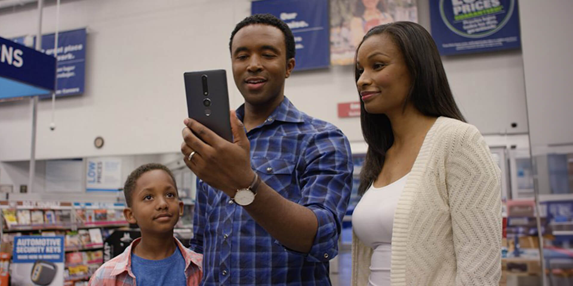 African-American family in a Lowes Home Improvement store using in-store navigation to find what they need.